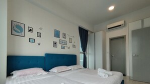 A hotel room with two beds, a large window with curtains, an air conditioning unit, and a door. - reStary Blue Dream Themed Homestay (Kota Kinabalu)