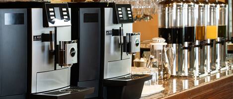 A row of espresso machines in a commercial setting.