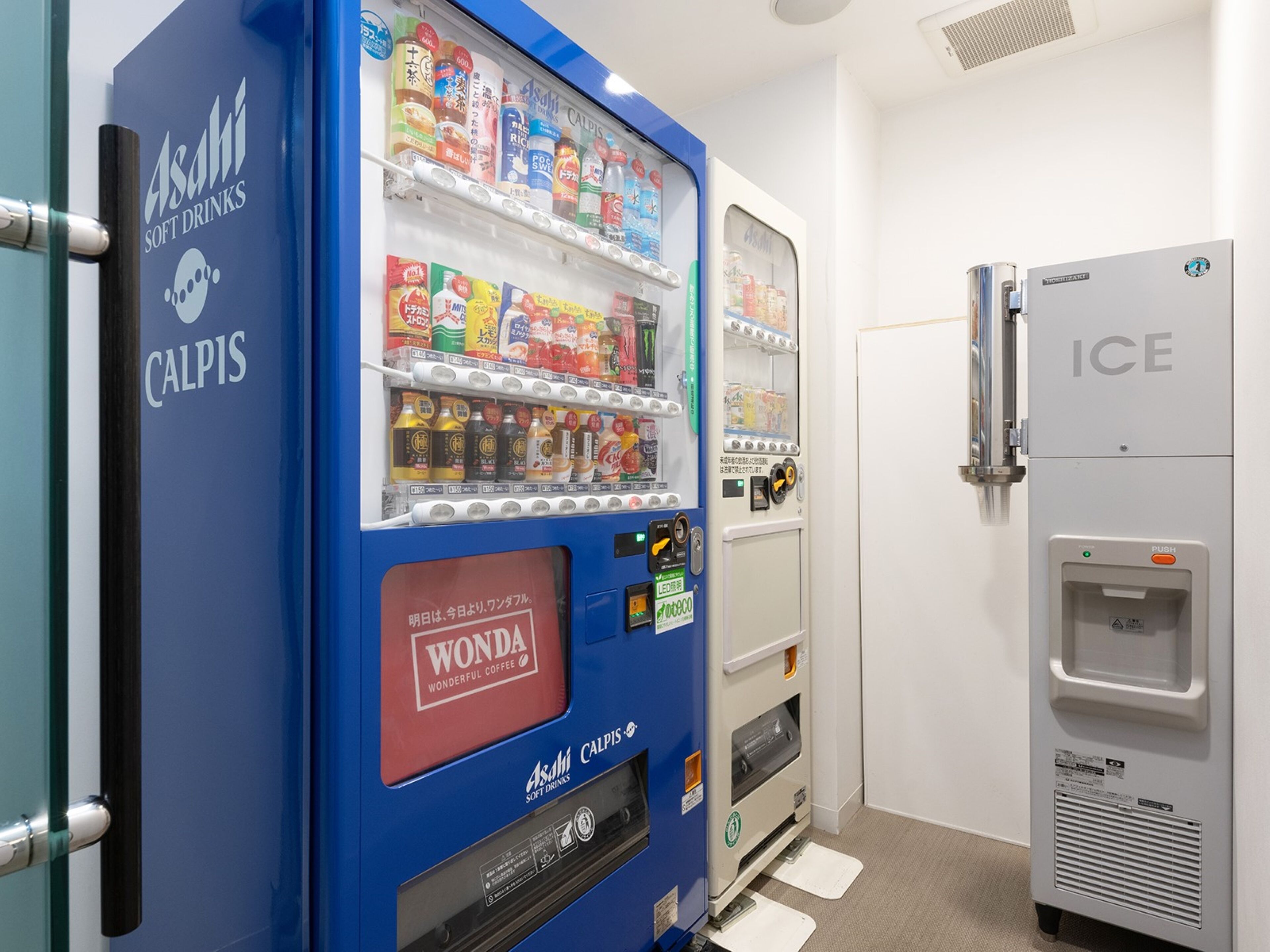 A vending machine with a blue exterior and a white interior, stocked with various beverages and snacks.