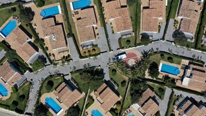 An aerial view of a residential area with multiple houses, each featuring a swimming pool and a tiled roof. - Villas Finesse Type 1 by Interhome (Son Bou)