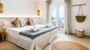 A bedroom with a bed, a view of the sea, a balcony, and a hanging basket. - Villa Atalis by Interhome (Son Bou)