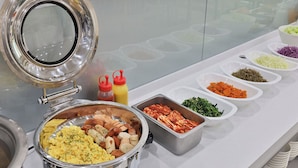 A buffet setup with various food items and condiments. - Hotel A1 Jukdo (Pohang)