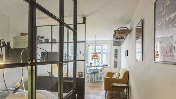A room with a bed, a desk, a chair, and a dining table. There are framed pictures on the wall and a window with a view of the outside. - "Marisol" - 700m from the sea by Interhome (Skagen)