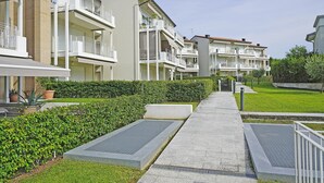 A row of modern apartment buildings with balconies, a well-maintained lawn, and a clear sky. - La Castellana Relax in Sirmione (Sirmione)