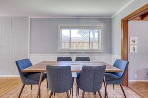 Enjoy meals in this dining area with a large window, wooden table, and four comfortable chairs.