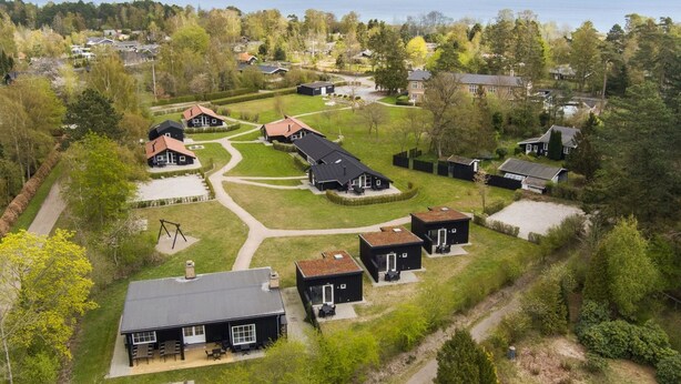 An aerial view of a residential area with houses, a clear sky, and a body of water in the background. - "Wehrhart" - 200m from the sea by Interhome (Væggerløse)