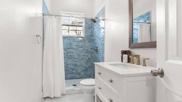 Shower, hair dryer, towels, shampoo