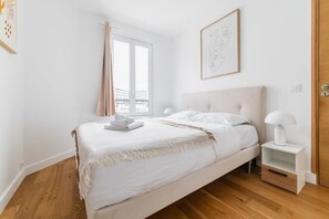 Relax in a serene bedroom with a large bed and city views.