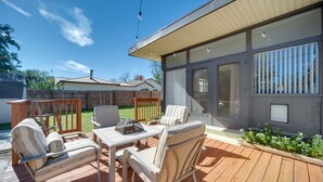 A deck with outdoor furniture, a pergola, and a view of a house. - Pet-Friendly Brady Vacation Home Near Wineries! (Brady)