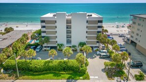 A multi-story hotel with a pool area and beach view. - Arie Dam 404 by Ryson Vacation Rentals (Madeira Beach)