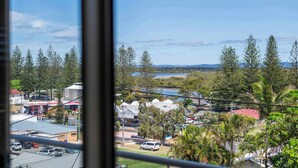A view from a window overlooking a town with buildings, trees, and a clear sky. - Poppy's Place - Oceanstays (Yamba)