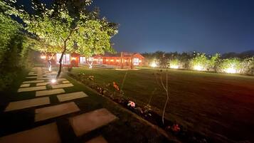 Stroll through the serene outdoor space, featuring a covered patio and beautifully landscaped surroundings.