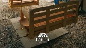 A beachside seating area with wooden benches and surfboards against the wall. - Habitat Surf Glamp (Cóbano)