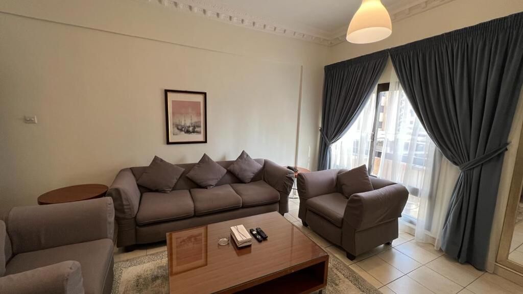 A modern living room with a sofa set, a coffee table, and a side table.