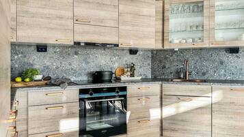 A kitchen with wooden cabinets, a built-in oven, and a granite countertop.