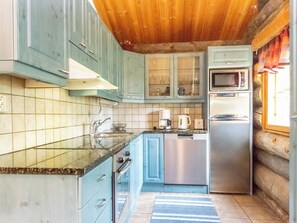 A kitchen with a refrigerator, microwave, and stove.