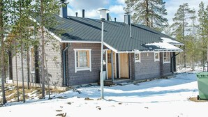 A small cabin with a sloped roof, a chimney, and a porch. - Kuksatie 7 a by Interhome (Inari)