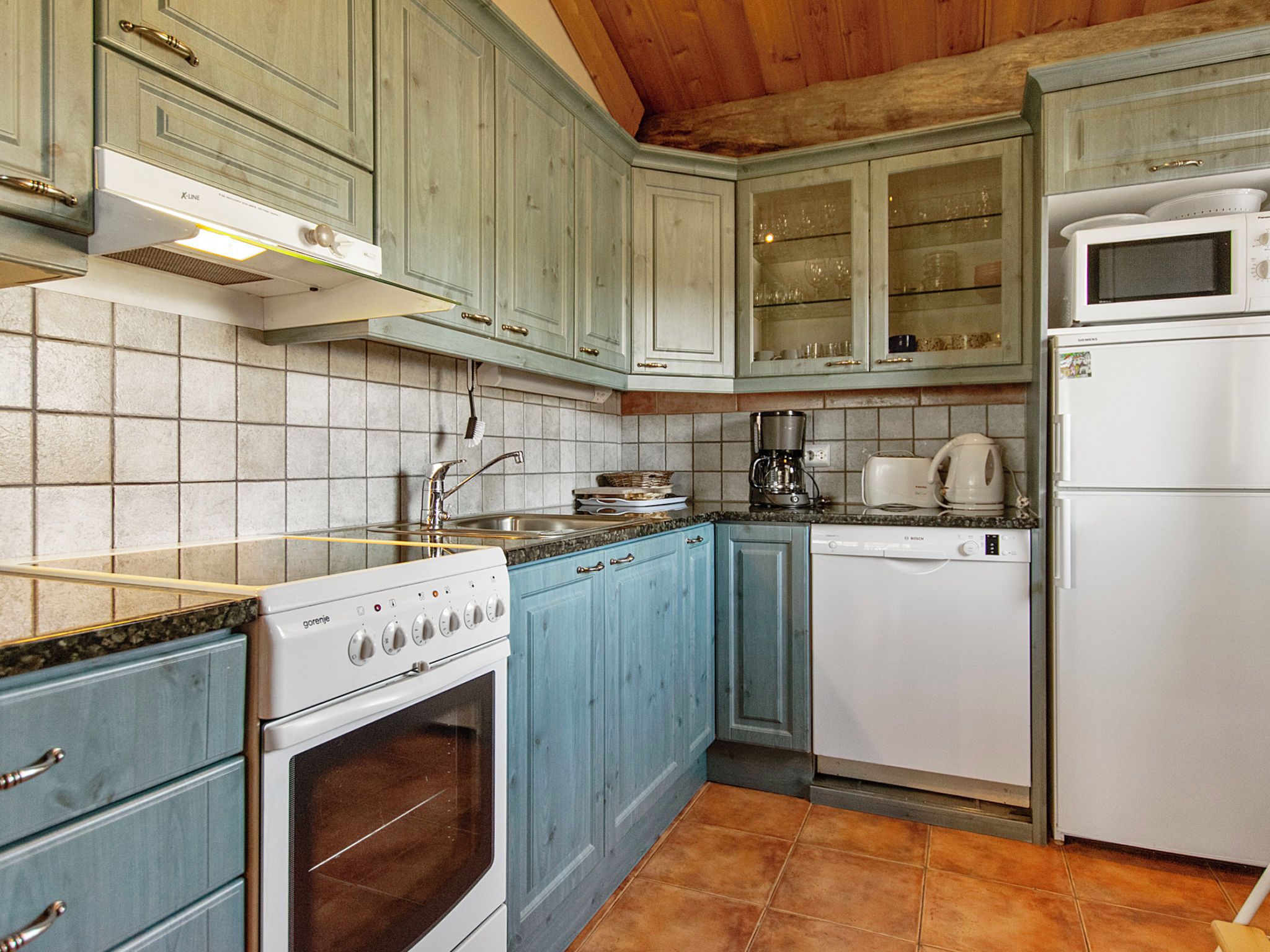 A kitchen with a stove, oven, dishwasher, and microwave.