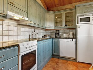A kitchen with a stove, oven, dishwasher, and microwave. - Kauniskelo a by Interhome (Inari)