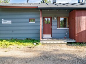 A building with a red door, a small window, and a sign indicating it is number 8.