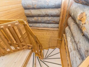 A wooden staircase with a handrail leading to a lower level. - Apartment Talles by Interhome (Inari)