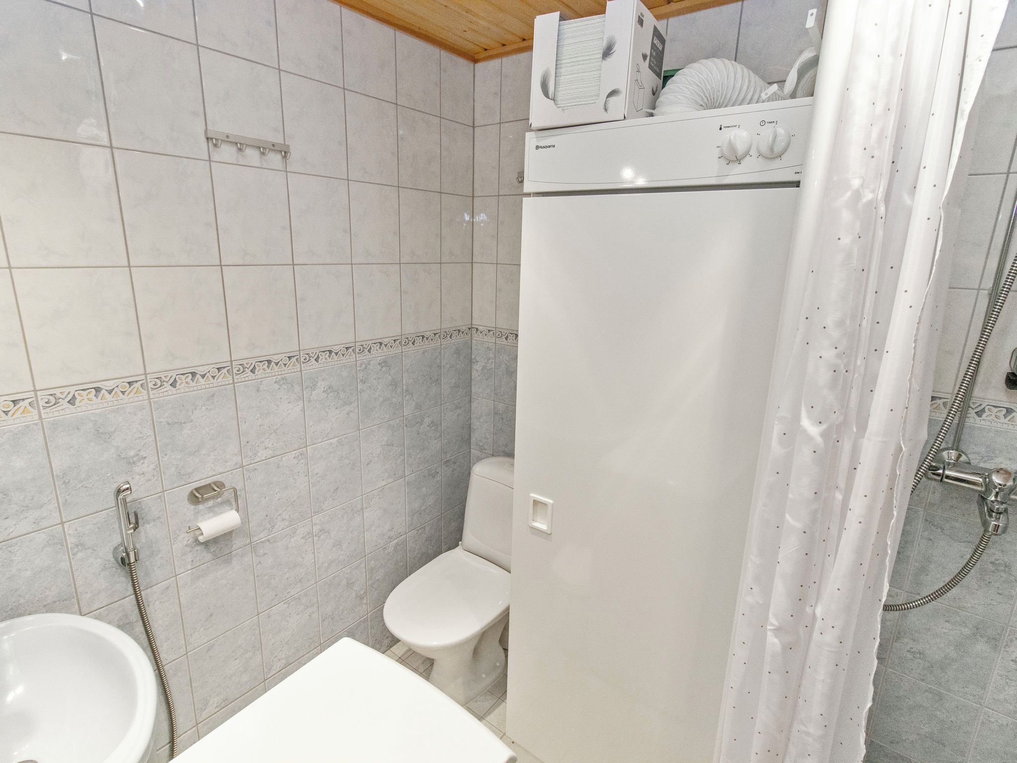 A bathroom with a toilet, sink, and shower.