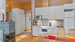 A modern kitchen with white cabinets, a built-in microwave, a stove, and a dishwasher.