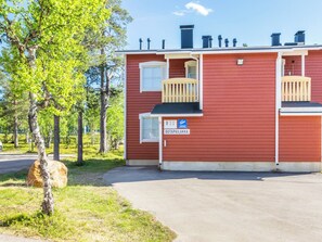 Un bâtiment rouge avec un petit balcon et une enseigne sur laquelle on peut lire « OUTPAILAKKA ».