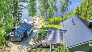 Un chalet au bord du lac, doté d’une terrasse et d’un petit quai.