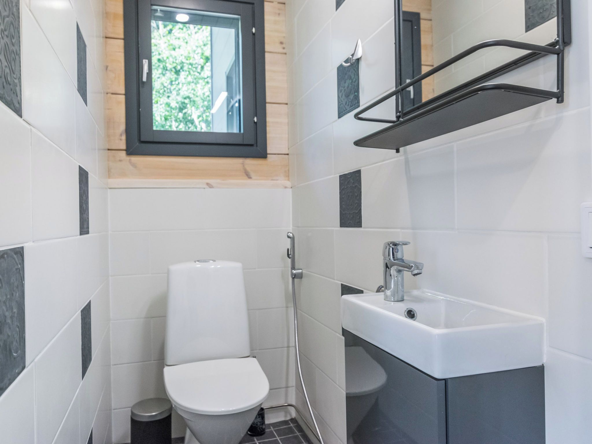 A compact bathroom with a toilet, a sink, and a shower.