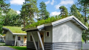 A cabin-style building with a sloped roof and a porch.