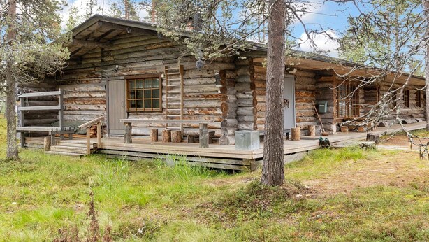 A rustic log cabin with a porch, wooden steps, and a small window. - Raahenmaja by Interhome (Inari)