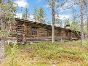 A log cabin with a simple, rustic design, surrounded by a forested area. - Raahenmaja by Interhome (Inari)