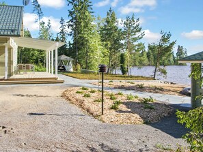 A waterfront property with a covered patio, a gazebo, and a small dock. - Riemurahi by Interhome (Pertunmaa)
