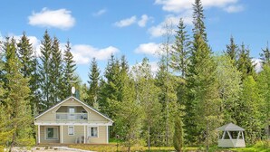 A cabin by a lake surrounded by trees. - Riemurahi by Interhome (Pertunmaa)