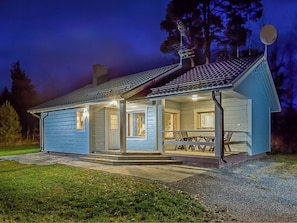 A small, single-story building with a porch and a dining area. - Onnimökki by Interhome (Pertunmaa)