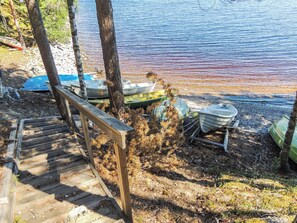 Un escalier en bois mène à une jetée où sont amarrés plusieurs bateaux.