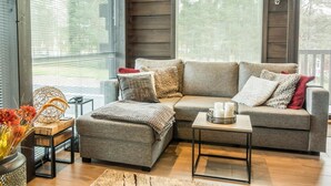 A cozy living room with a sectional sofa, a coffee table, and a decorative skull on the wall. - Levi platinum 2 b 6 by Interhome (Kittilä)
