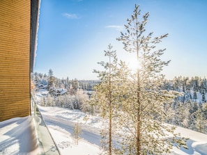 A snowy landscape with a clear view of a forest and a road. - Villa voimapolku 9 a 2 by Interhome (Kuusamo)