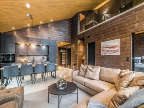 A modern interior with a dining area, kitchen, and living space.