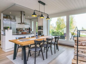 A modern kitchen with a central island, stainless steel appliances, and pendant lighting. - Kiviniemi by Interhome (Kerimäki)