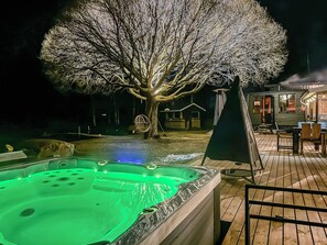 A hot tub with a tree illuminated in the background. - Kiviniemi by Interhome (Kerimäki)