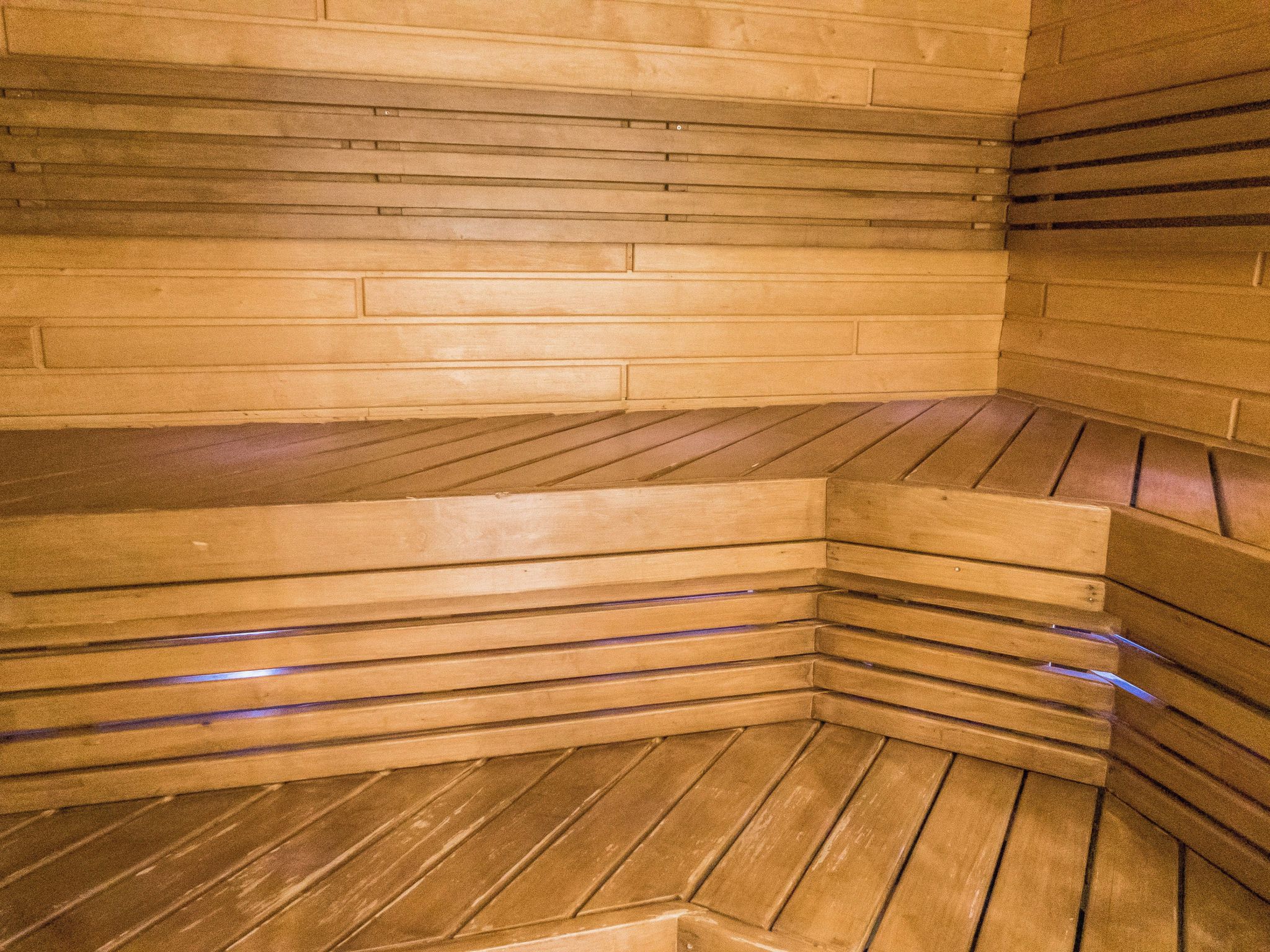 A sauna with wooden benches and walls.