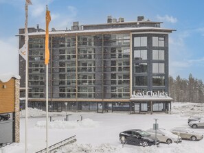 A modern building with multiple windows and a sign reading "Levi Chalet". - Levi chalets 1602 by Interhome (Kittilä)