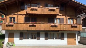 A multi-story wooden building with balconies and windows, likely a hotel or guesthouse. - Alpenglühn by Interhome (Adelboden)
