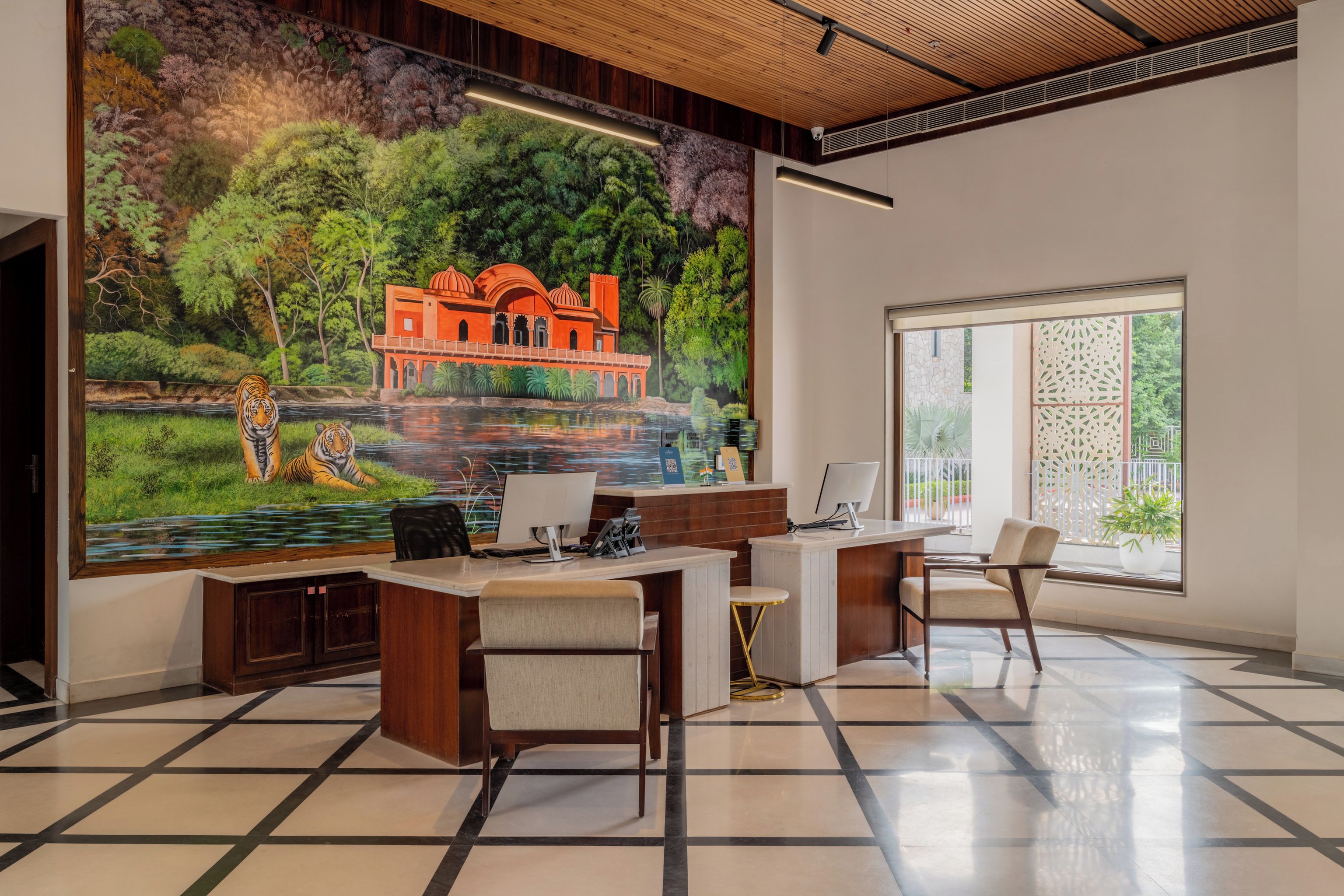 A modern office with a large mural of a traditional building and a river scene.
