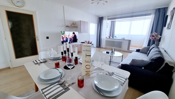 Un salon moderne avec un coin repas aménagé pour le dîner.