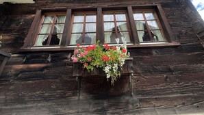 A traditional wooden building with multiple windows and a balcony. - Ferienhaus Lomatte 1758 by Interhome (Saas-Fee)