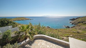 A coastal view with a stone pathway leading to a seating area overlooking the sea. - Sanarte villa 2, 5br w/private pool and sea view! (Mykonos)