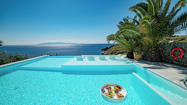 A clear blue infinity pool with a view of the ocean and mountains. - Sanarte villa 2, 5br w/private pool and sea view! (Mykonos)
